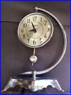 C1938 Art Deco Howard Miller clock w demilune support & electro pendulum