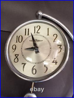 C1938 Art Deco Howard Miller clock w demilune support & electro pendulum